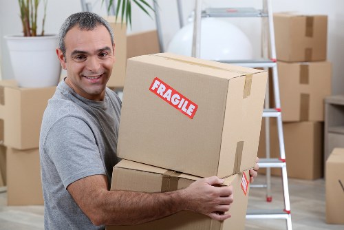 Same-day removals team working in Bow with furniture and boxes