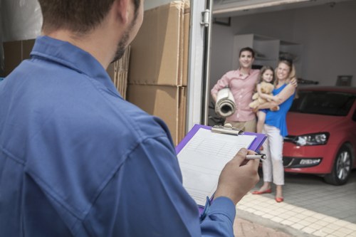 A removals team estimating cubic-yard volume for a two-bedroom Bow home